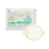 A Tegaderm Film 1630 adhesive patch shown in front of its retail packaging on a plain white background. The packaging is white with teal and red 3M branding, and the round patch has a pale beige adhesive area with a translucent outer edge.