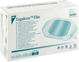 A box of 3M Tegaderm Film 1624W transparent film dressing frame style, shown on a plain white background. The packaging is white with teal text and graphics.