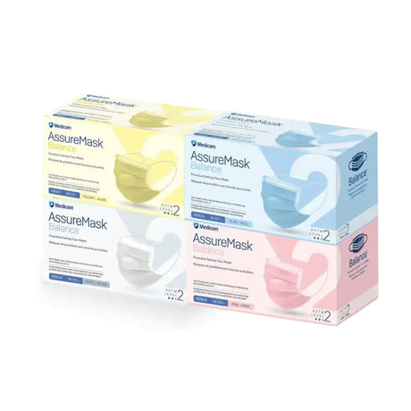 Four Medicom AssureMask Balance face masks in retail packaging, arranged in a 2x2 grid. The boxes are shown in four colorways: yellow and white (Tonic and Lime), light blue and white (Blue), and pink and white (Pink).